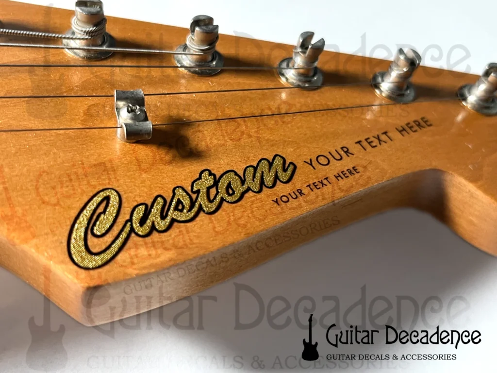 main listing picture for classic metallic gold screen printed decal on a stratocaster style headstock