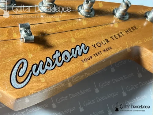 Close up of classic metallic silver guitar decal on a stratocaster style headstock